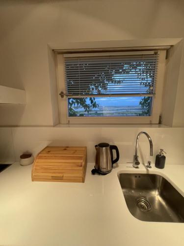 a kitchen counter with a sink and a window at Luxury Penthouse with 2 Pools in a Monastery in Tavira