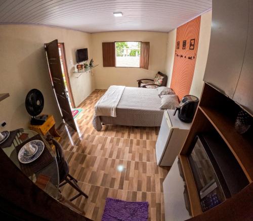 a small bedroom with a bed and a fireplace at Chalé Raiz da Serra in Gravatá