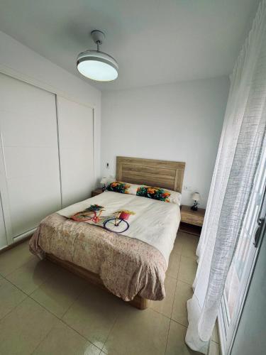 a bedroom with a large bed with flowers on it at Apartamento Tiana in Ayamonte