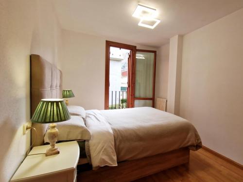a bedroom with a bed and a lamp on a nightstand at Villmor - B53 - Coma De Albá, 1º in Benasque