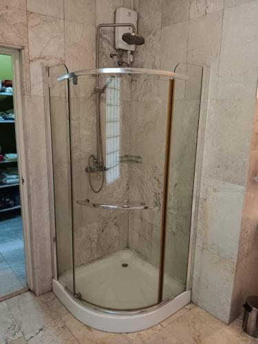 a shower with a glass door in a bathroom at Thai River House in Ban Kat Khi Lek