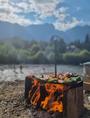 a cake sitting on the ground next to a lake at Casa Mathias in Buşteni