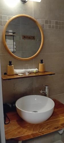 a bathroom with a white sink and a mirror at Dikke Vriend , herberg & taverne in Chiny