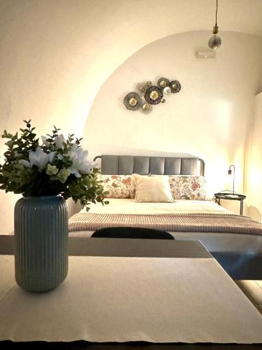 a bedroom with a bed with a vase of flowers at Gaia Home in Capurso