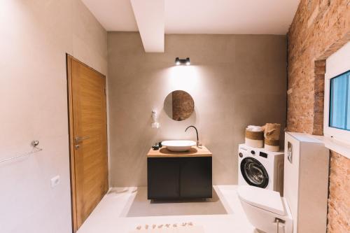 a bathroom with a sink and a washing machine at La Mer Beach Residence in Ulcinj