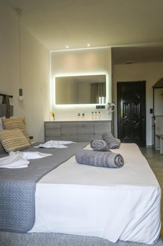 a bedroom with two beds with towels on them at Giabeos Skiathos in Troulos