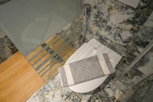 a bathroom with a toilet and a chair in a room at Giabeos Skiathos in Troulos