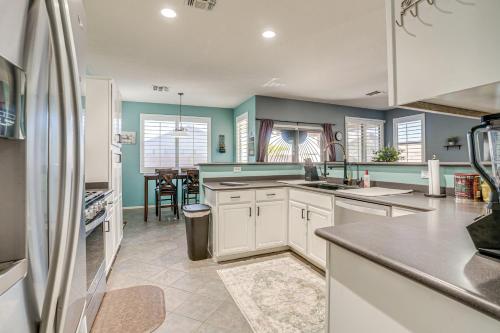 a kitchen with white cabinets and a dining room at Avondale Getaway Less Than 8 Mi to Estrella Mountain! in Avondale