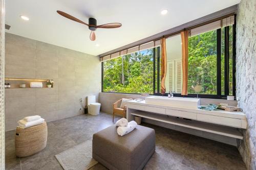 a bathroom with a large tub and a large window at Villa Bond Seaview Villa in Chaweng Noi Beach