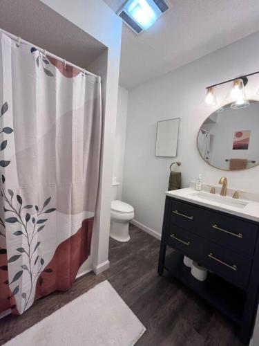 a bathroom with a sink and a shower curtain at Hot Tub, Panoramic Views, Deck, Firepit in Beech Mountain