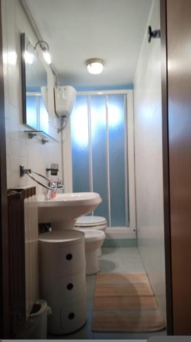 a bathroom with a sink and a toilet and a window at Good Vibes Apartment in Monterosso al Mare