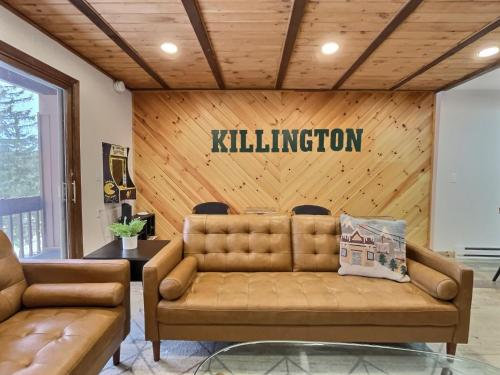 a living room with a couch and a sign that reads killington at BearHug AC, Pool, Hot Tub, Tennis, Close to Resort in Killington