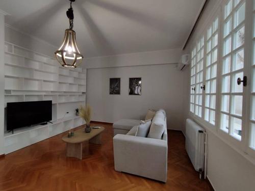 a living room with a couch and a tv at Kolonaki 2 bedroom Flat in Athens