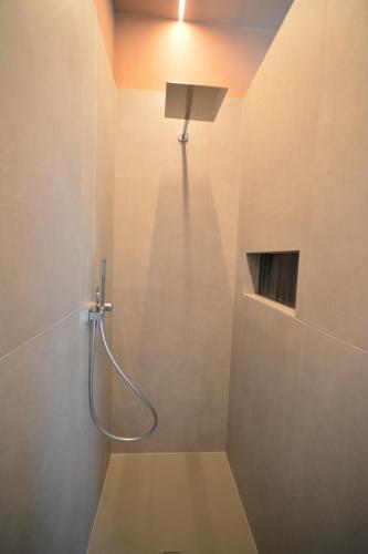 a shower with a shower head in a bathroom at Locanda Parsifal in Parma