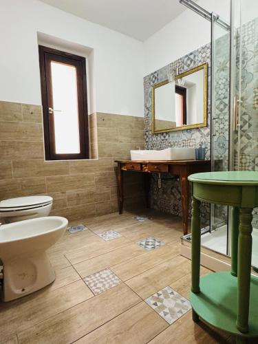 a bathroom with a toilet and a sink and a shower at Casa Lulù in Cala Gonone