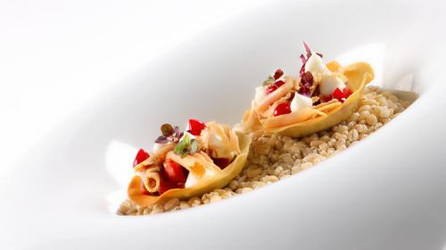 two food items sitting on top of a plate at Hotel Weiher Green Lake in Falzes