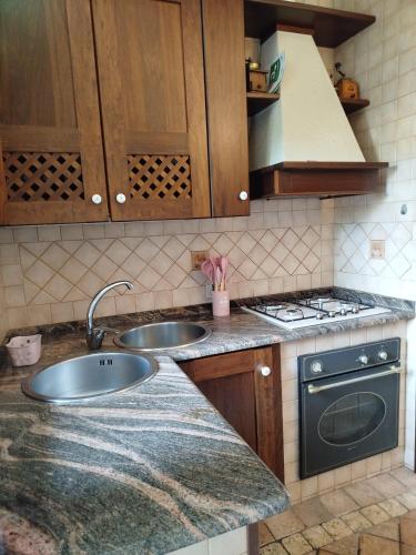 a kitchen with two sinks and a stove at Holiday Vibes Relax in Quartu SantʼElena