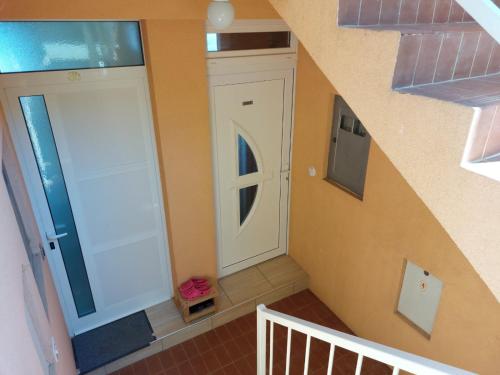 a staircase with a white door in a house at Apartment Jenul in Labin