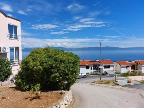 a street in a town with a tree at Apartment Jenul in Labin