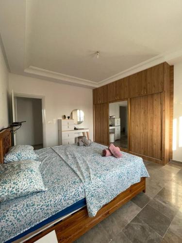 a bedroom with a bed with two stuffed animals on it at Corniche in Sousse