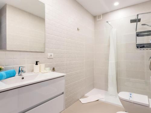 ein weißes Badezimmer mit Waschbecken und Toilette in der Unterkunft Wonderful Attic in Playa Paraiso in Playa Paraiso