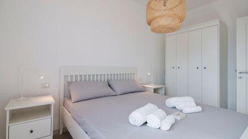 a bedroom with a bed with towels on it at Panoramic Seaview in Olbia