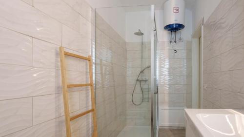 a bathroom with a shower with a glass door at Panoramic Seaview in Olbia