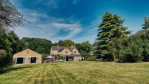 an image of a house with a large yard at York Cottage House & Spa in Bozeat