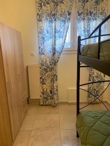 a bedroom with a bunk bed and a window at Lanari Valley House in Thérmi