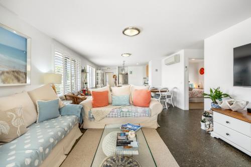 a living room with a couch and a table at Orford Coastal Retreat by Peppy Beach Retreats in Orford
