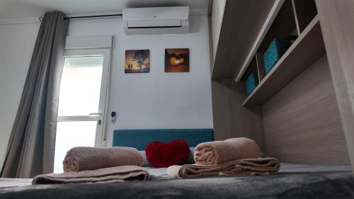 a bedroom with a bed with towels on it at Apartalux Sublime Plus in Las Negras