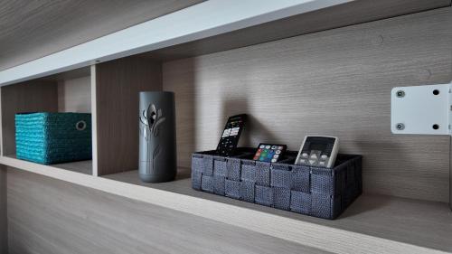 a shelf with two cell phones on it at Apartalux Sublime Plus in Las Negras