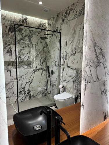 a bathroom with a shower and a toilet at Aquazul, Green Coast in Palasë