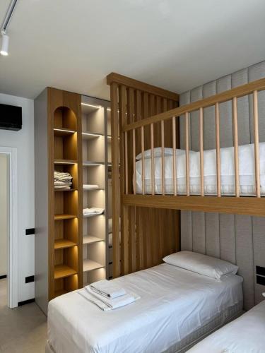 a bedroom with two bunk beds and a tv at Aquazul, Green Coast in Palasë