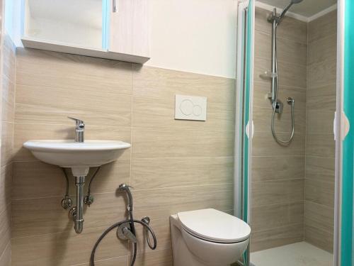 a bathroom with a sink and a toilet and a shower at Apt in the heart of Perugia, near Corso Vannucci in Perugia