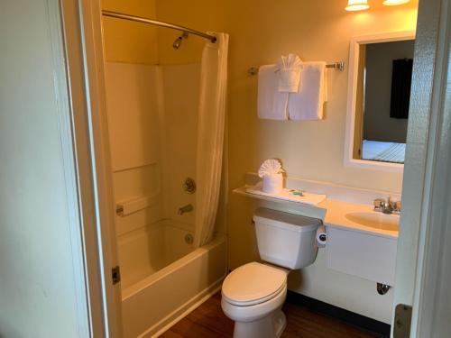 a bathroom with a toilet and a sink and a shower at Motel 6 Myrtle Beach in Myrtle Beach