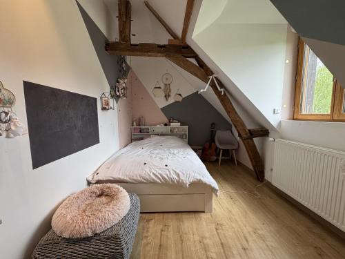a bedroom with a bed in a attic at La Parenthèse Verte - 8pers - Piscine - Rêve au Mans in Roézé-sur-Sarthe
