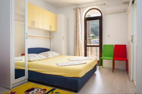 a bedroom with a bed with a mirror on it at Apartmani Mira in Drasnice