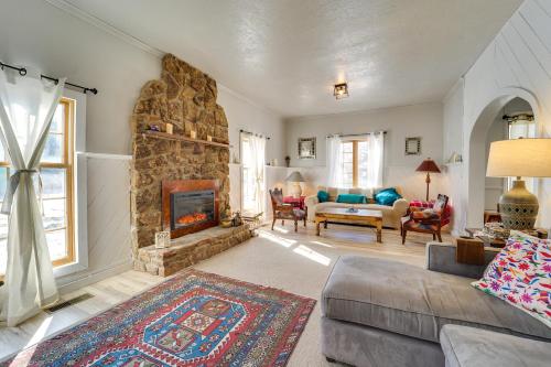 a living room with a couch and a fireplace at Dolorable Home with Yard - Walk to River! in Dolores