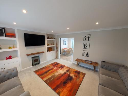 a living room with a couch and a fireplace at 3 Bed-Sleeps 5-Garden-Parking-Pets in Carlisle