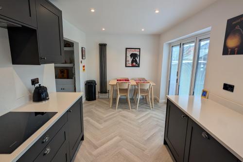 a kitchen with a table and a dining room at 3 Bed-Sleeps 5-Garden-Parking-Pets in Carlisle