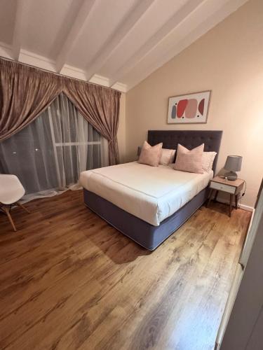 a bedroom with a large bed and a window at Olives by Agnes 33 in Hartbeespoort