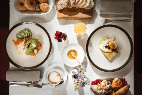 a table topped with plates of food and drinks at Grand Hotel Adriatico in Florence