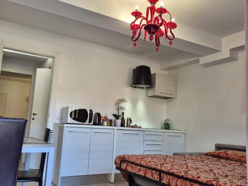 a kitchen with a red chandelier in a room at Prince Apartments in Venice