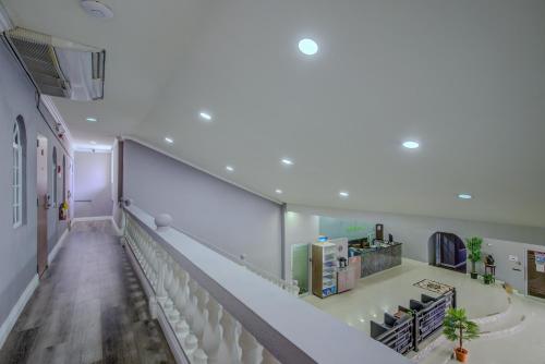 an empty hallway with a staircase in a building at Airport Suites Hotel in Piarco