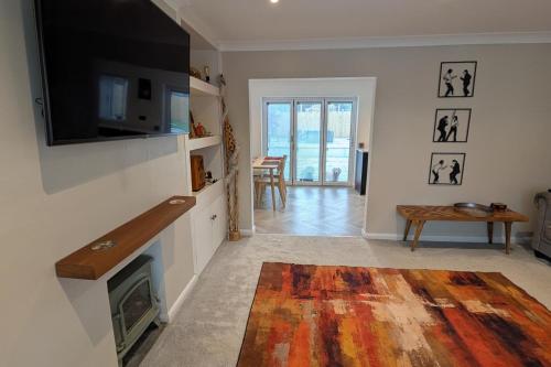 a living room with a fireplace and a flat screen tv at 3 Bed-Sleeps 5-Garden-Parking-Pets in Carlisle