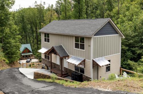 an aerial view of a house with a driveway at Falling Brook – Cozy Creekside Cabin with Hot Tub, Game Loft & Dog-Friendly Comfort in Gatlinburg