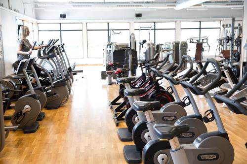 a gym with rows of treadmills and machines at Ljungsbro Vandrarhem in Ljungsbro