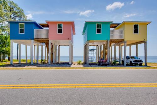 a row of houses on posts next to the ocean at Beach and Dock Access Lanark Village Escape! in Lanark Village