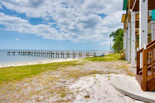 a house on the beach with a pier at Beachfront Retreat with Dock in Lanark Village! in Lanark Village